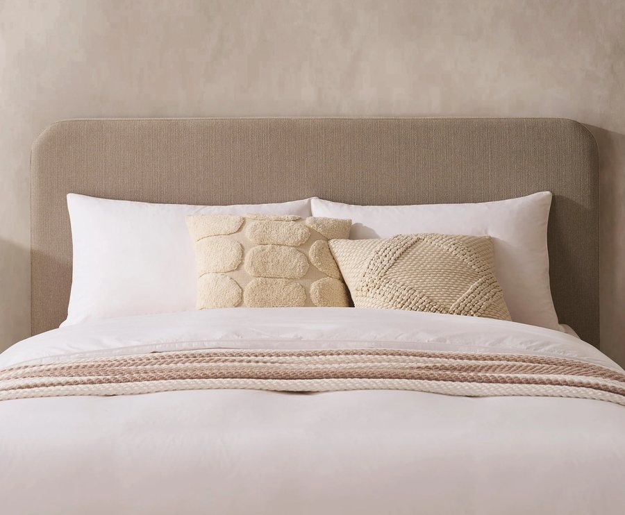 Calm bedroom with an upholstered bed and soft cushions