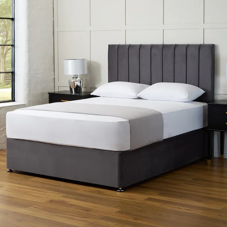Grey divan bed with a panelled headboard